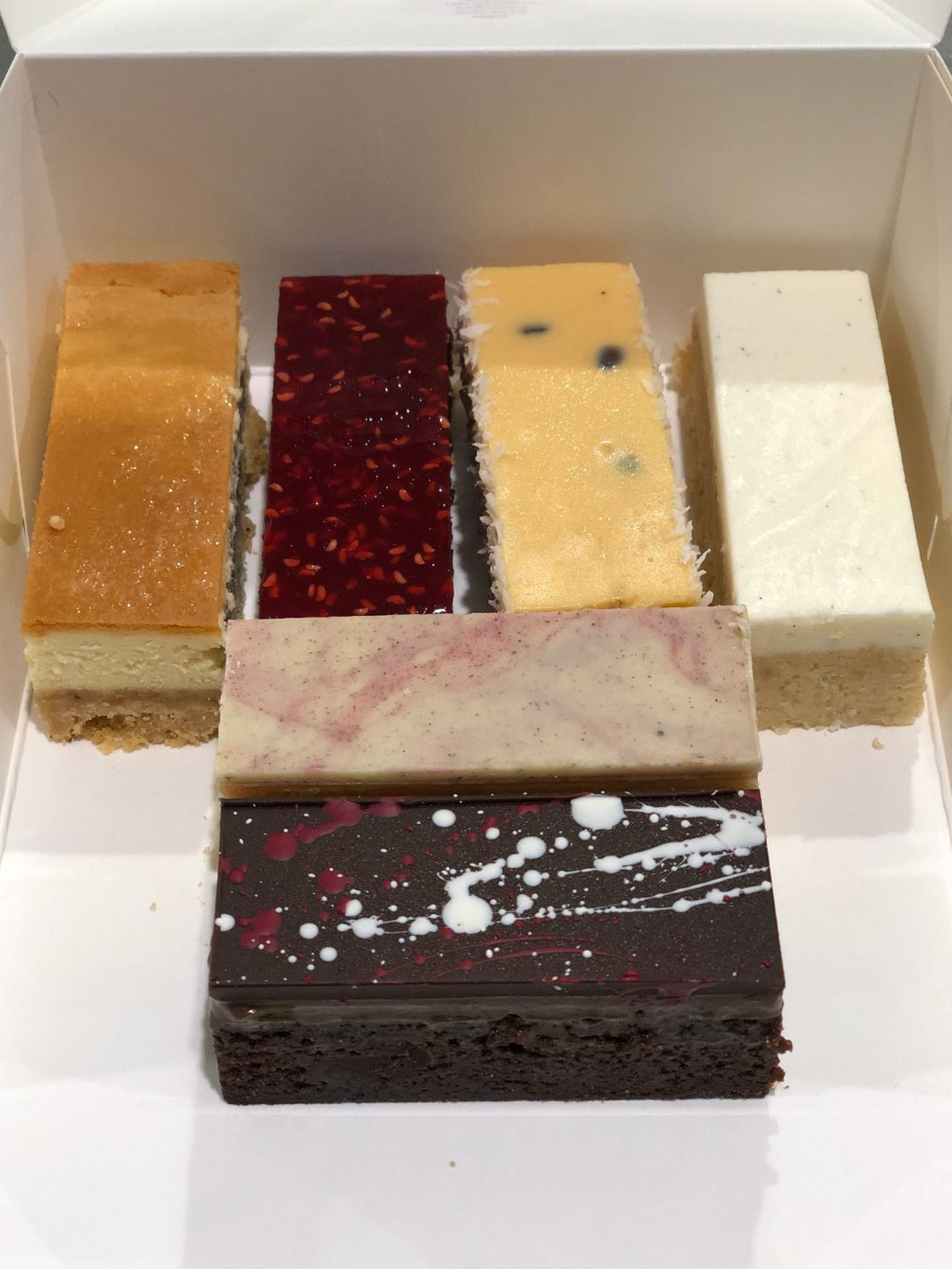 Gluten Free Assorted Desserts 100% Gluten Free New York Cheesecake Plant Based Lemon Slice Photo of 6 Gluten Free Dessert Bars Salted Caramel Raspberry Chocolate Mud Lemon and Passionfruit Tart Coffee Caramel Gluten Free Bakery Northcote Dandenong